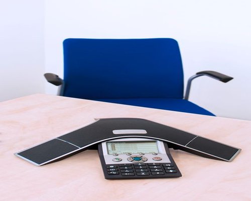 A clean, structured meeting desk representing open communications and professional support